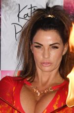 KATIE PRICE Fire Breathing at Her New Book Playing with Fire Photocall in London 01/17/2017