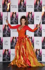 KATIE PRICE Fire Breathing at Her New Book Playing with Fire Photocall in London 01/17/2017