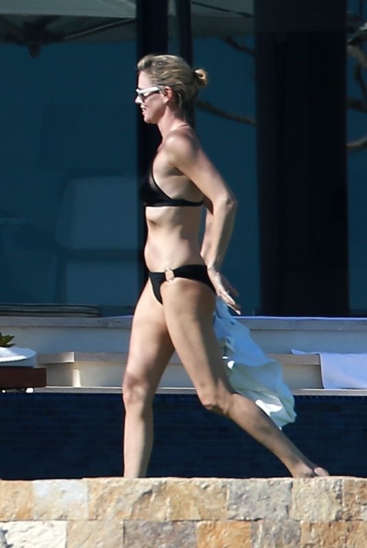 CHARLIZE THERON in Bikini on the Beach in Los Cabos 11/23/2017