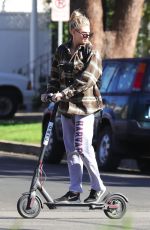 CHARLOTTE MCKINNEY Tides a Bird Scooter in Santa Monica 12/18/2017