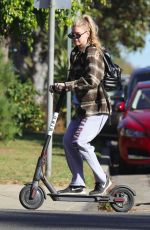 CHARLOTTE MCKINNEY Tides a Bird Scooter in Santa Monica 12/18/2017