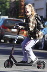 CHARLOTTE MCKINNEY Tides a Bird Scooter in Santa Monica 12/18/2017
