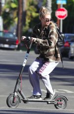 CHARLOTTE MCKINNEY Tides a Bird Scooter in Santa Monica 12/18/2017