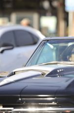 CINDY CRAWFORD and Rande Gerber in Classic Corvette Convertible Driving Out in Malibu 12/23/2017