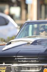 CINDY CRAWFORD and Rande Gerber in Classic Corvette Convertible Driving Out in Malibu 12/23/2017