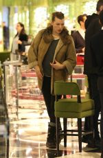 MILLA JOVOVICH and Paul W. S. Anderson Shopping at Prada in Beverly Hills 12/21/2017
