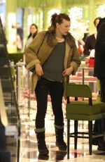 MILLA JOVOVICH and Paul W. S. Anderson Shopping at Prada in Beverly Hills 12/21/2017
