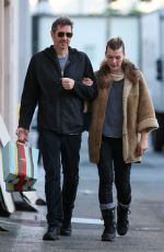 MILLA JOVOVICH and Paul W. S. Anderson Shopping at Prada in Beverly Hills 12/21/2017