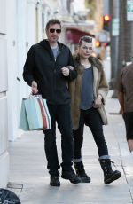 MILLA JOVOVICH and Paul W. S. Anderson Shopping at Prada in Beverly Hills 12/21/2017