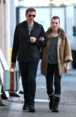 MILLA JOVOVICH and Paul W. S. Anderson Shopping at Prada in Beverly Hills 12/21/2017