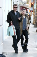 MILLA JOVOVICH and Paul W. S. Anderson Shopping at Prada in Beverly Hills 12/21/2017