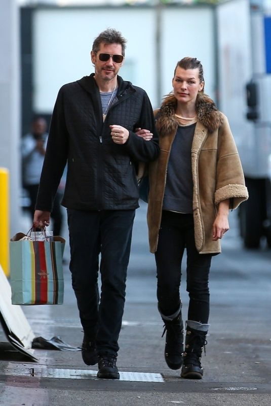 MILLA JOVOVICH and Paul W. S. Anderson Shopping at Prada in Beverly Hills 12/21/2017