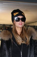 PARIS HILTON and Chris Zylka at Heathrow Airport in London 12/20/2017