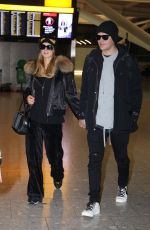 PARIS HILTON and Chris Zylka at Heathrow Airport in London 12/20/2017