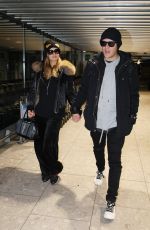 PARIS HILTON and Chris Zylka at Heathrow Airport in London 12/20/2017