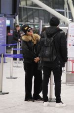 PARIS HILTON and Chris Zylka at Heathrow Airport in London 12/20/2017