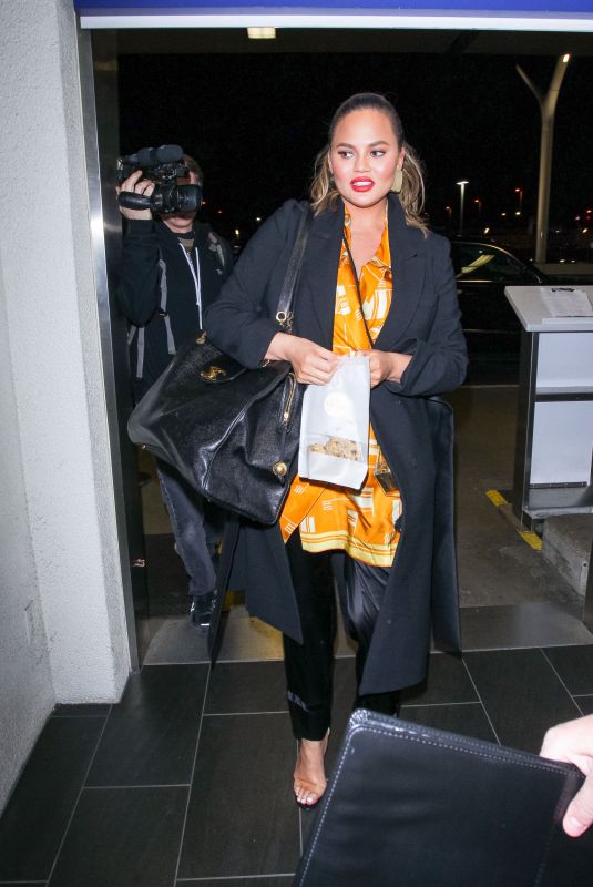 CHRISSY TEIGEN at LAX Airport in Los Angeles 02/24/2018