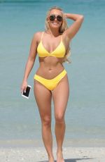 AMBER TURNER in Yellow Bikini at a Beach in Dubai 03/09/2018