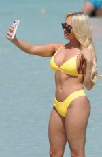 AMBER TURNER in Yellow Bikini at a Beach in Dubai 03/09/2018