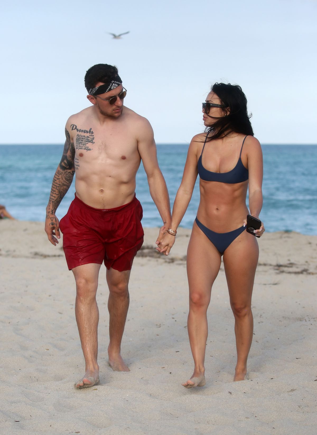 BRE TIESI in Bikini and Johnny Manziel at a Beach in Miami 03/01/2018.