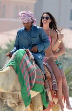 DANIELLE LLOYD in Bikini Riding a Camel on the Beach in Dubai 03/30/2018