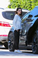 MILA KUNIS Returns to Her Tesla Model 3 Car in Los Angeles 03/27/2018