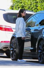 MILA KUNIS Returns to Her Tesla Model 3 Car in Los Angeles 03/27/2018