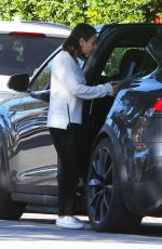 MILA KUNIS Returns to Her Tesla Model 3 Car in Los Angeles 03/27/2018