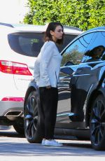 MILA KUNIS Returns to Her Tesla Model 3 Car in Los Angeles 03/27/2018