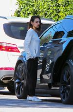 MILA KUNIS Returns to Her Tesla Model 3 Car in Los Angeles 03/27/2018