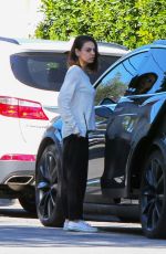 MILA KUNIS Returns to Her Tesla Model 3 Car in Los Angeles 03/27/2018