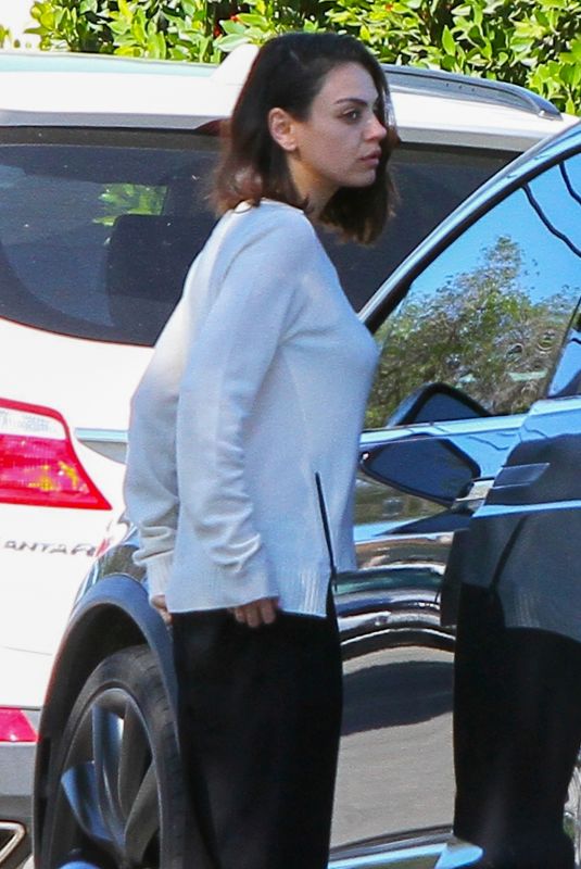 MILA KUNIS Returns to Her Tesla Model 3 Car in Los Angeles 03/27/2018