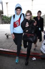 NICOLA PELTZ and Anwar Hadid at LAX Airport in Los Angeles 03/07/2018