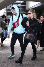 NICOLA PELTZ and Anwar Hadid at LAX Airport in Los Angeles 03/07/2018