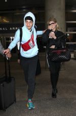 NICOLA PELTZ and Anwar Hadid at LAX Airport in Los Angeles 03/07/2018