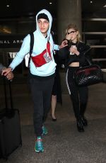 NICOLA PELTZ and Anwar Hadid at LAX Airport in Los Angeles 03/07/2018