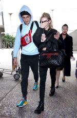 NICOLA PELTZ and Anwar Hadid at LAX Airport in Los Angeles 03/07/2018