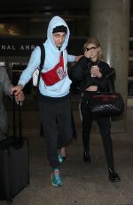 NICOLA PELTZ and Anwar Hadid at LAX Airport in Los Angeles 03/07/2018