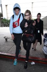 NICOLA PELTZ and Anwar Hadid at LAX Airport in Los Angeles 03/07/2018