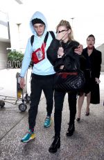 NICOLA PELTZ and Anwar Hadid at LAX Airport in Los Angeles 03/07/2018
