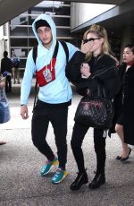 NICOLA PELTZ and Anwar Hadid at LAX Airport in Los Angeles 03/07/2018