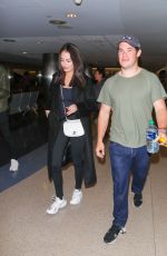 CHLOE BRIDGES and Adam Devine at LAX Airport in Los Angeles 04/20/2018
