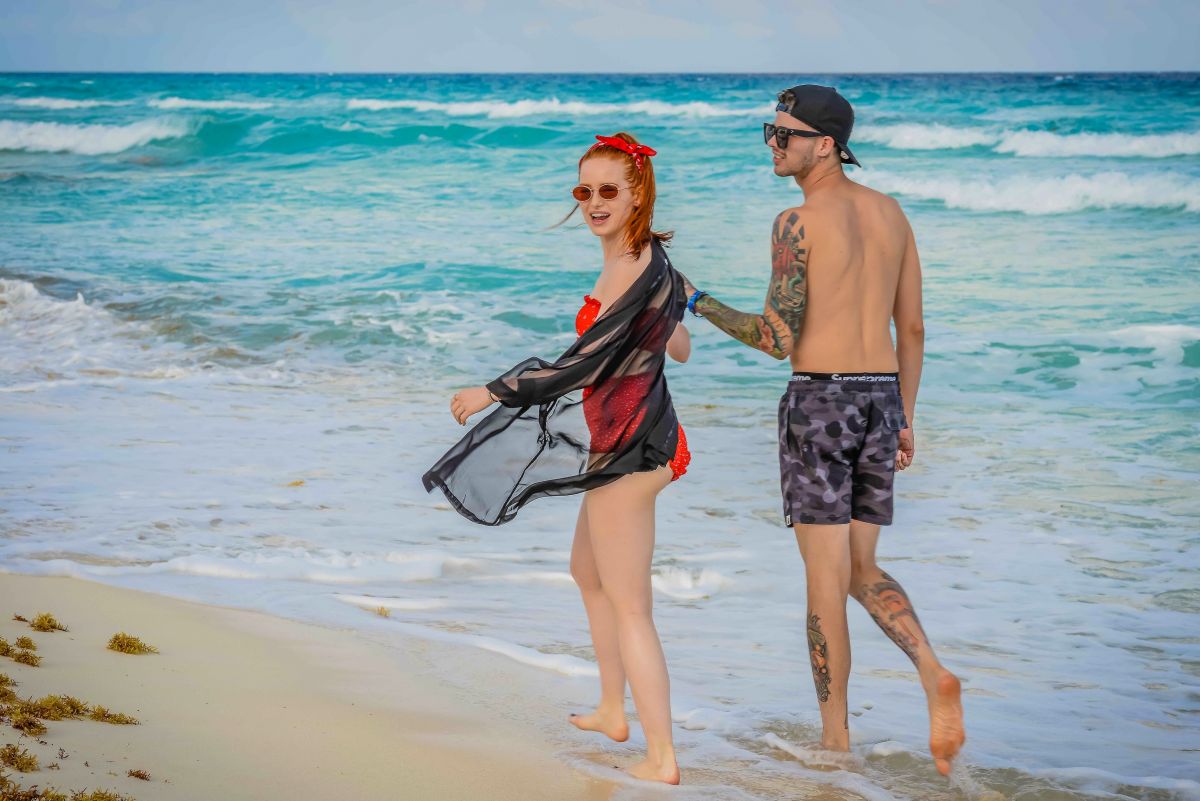 MADELAINE PETSCH and Travis Mills at a Beach in Cancun 04/18/2018.
