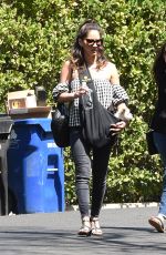 OLIVIA MUNN Carrying Her Dog in a Dog Pouch Out in Los Angeles 04/10/2018