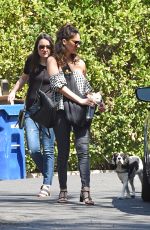 OLIVIA MUNN Carrying Her Dog in a Dog Pouch Out in Los Angeles 04/10/2018