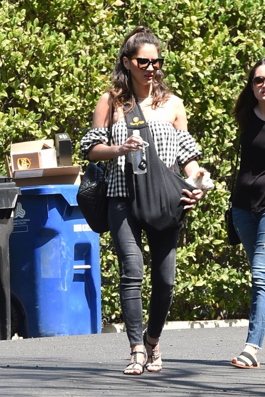 OLIVIA MUNN Carrying Her Dog in a Dog Pouch Out in Los Angeles 04/10/2018