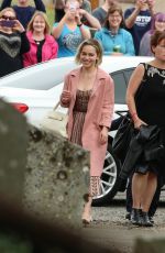 EMILIA CLARKE Arrives at Kit Harington and Rose Leslie