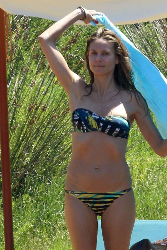 HEIDI KLUM in Bikini at a Beach in Corsica 07/25/2018