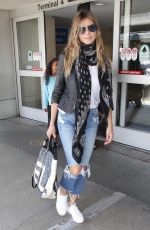 HEIDI KLUM in Ripped Jeans at LAX Airport in Los Angeles 07/08/2018