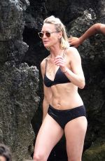 ROBIN WRIGHT in Bikini and Clement Giraudet at a Beach in Capri 07/22/2018